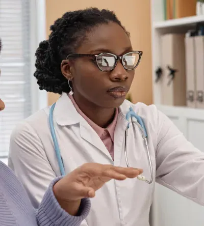 Primary care nurse practitioner with DNP reviewing treatment with patient